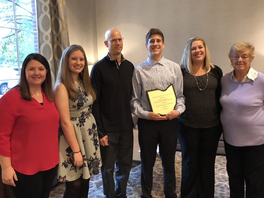 Maxx and family holding award