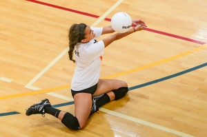girl bumping volleyball from the ground