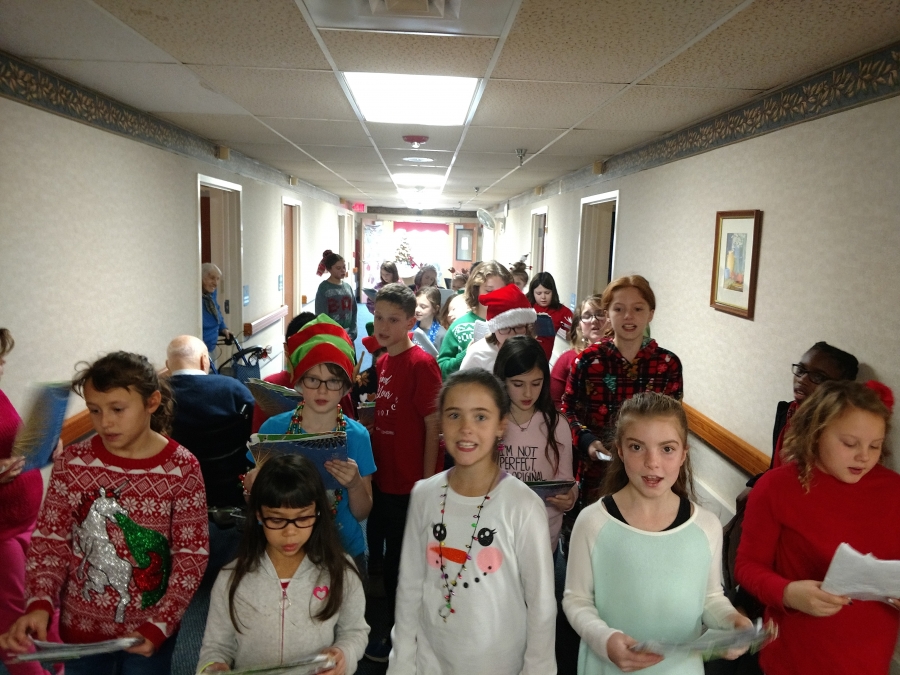 students carolling in the hallway
