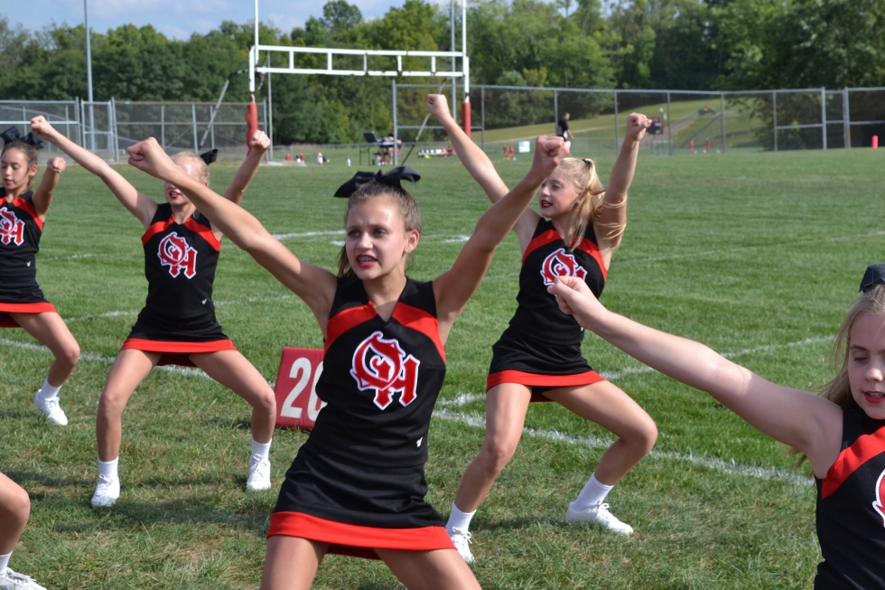 Delhi Middle School cheerleaders with arms up