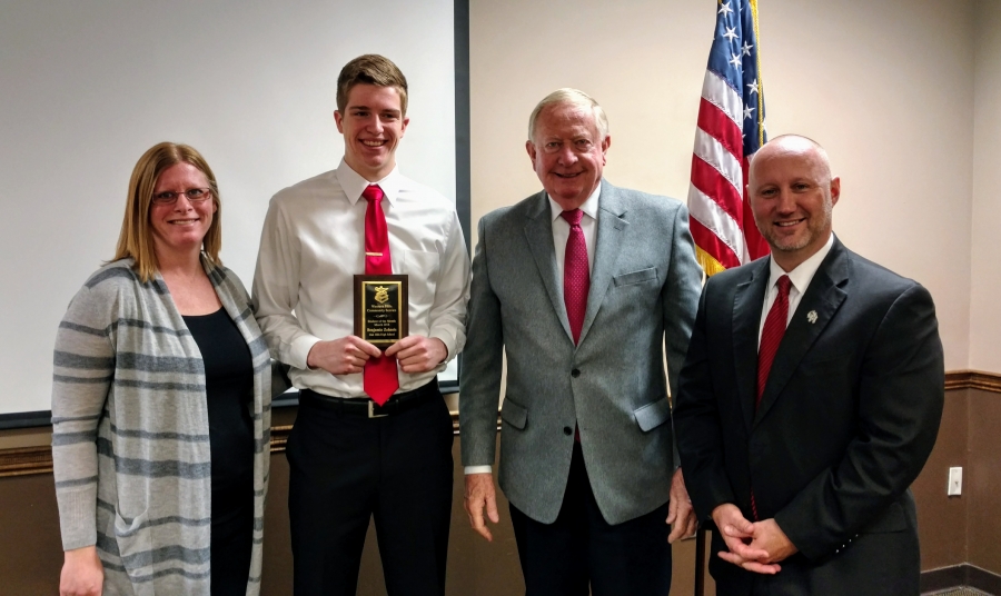 Ben Zahneis holds plaque with members of Western Hills Community Service Club