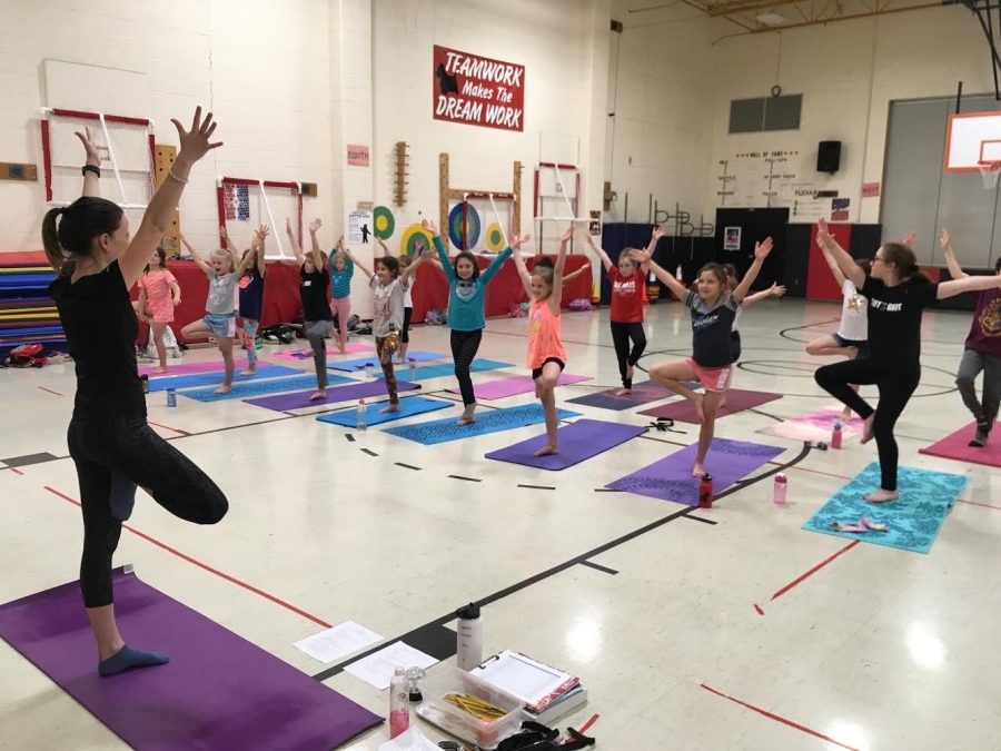 students doing yoga in the gym