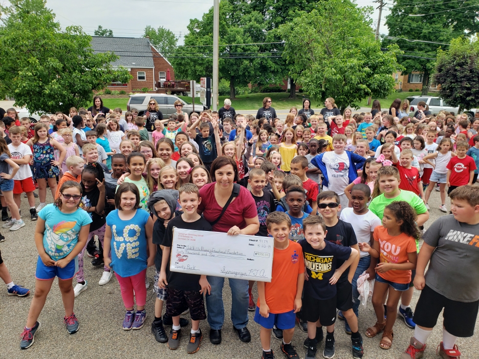 PTA with giant check and students