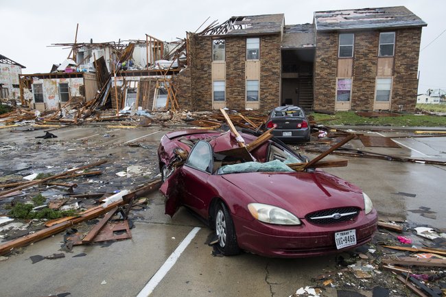 Damage to a car and Houses after Hurricane Harvey