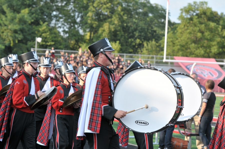 Drumline marching at football game.